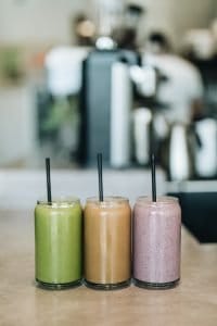 3 smoothies on a table